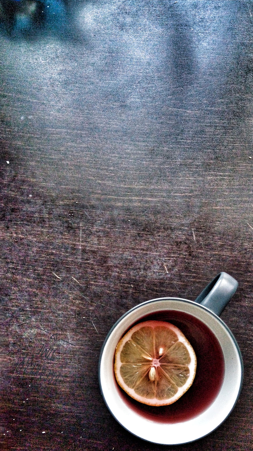 Top View of Hot Tea with Lemon Slice on Dark Wood