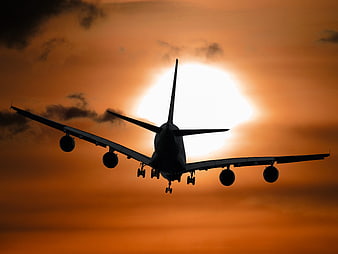 Silhouette of Four-Engine Airplane Landing at Sunset