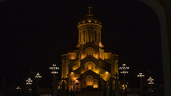 Illuminated Orthodox Cathedral at Night with Golden Dome