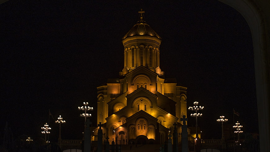 Illuminated Orthodox Cathedral at Night with Golden Dome