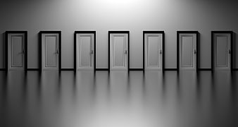 Row of white doors in a minimalist gray hallway