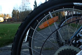 Close-up of bicycle wheel with orange reflector and tire