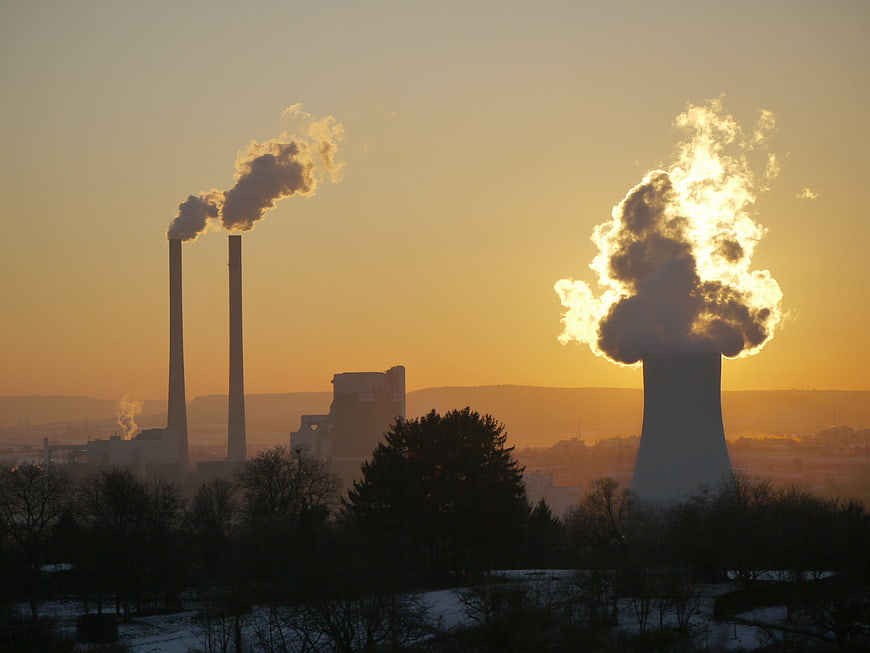Industrial Power Plant Silhouette Against Golden Sunset Sky