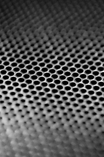 Close-up of perforated metal sheet with circular holes