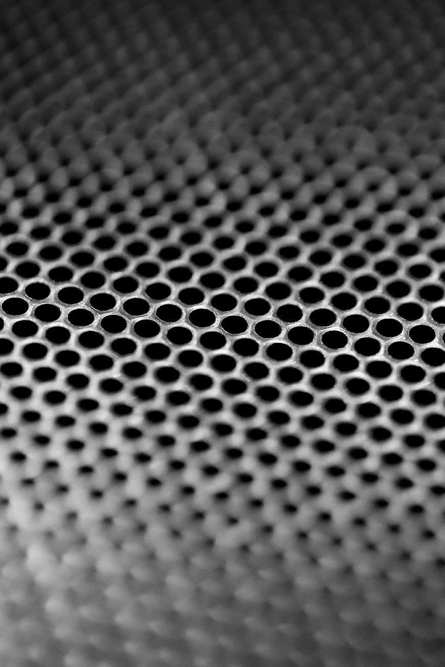 Close-up of perforated metal sheet with circular holes