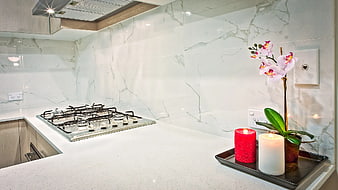 Modern kitchen countertop with gas stove and decorative candles