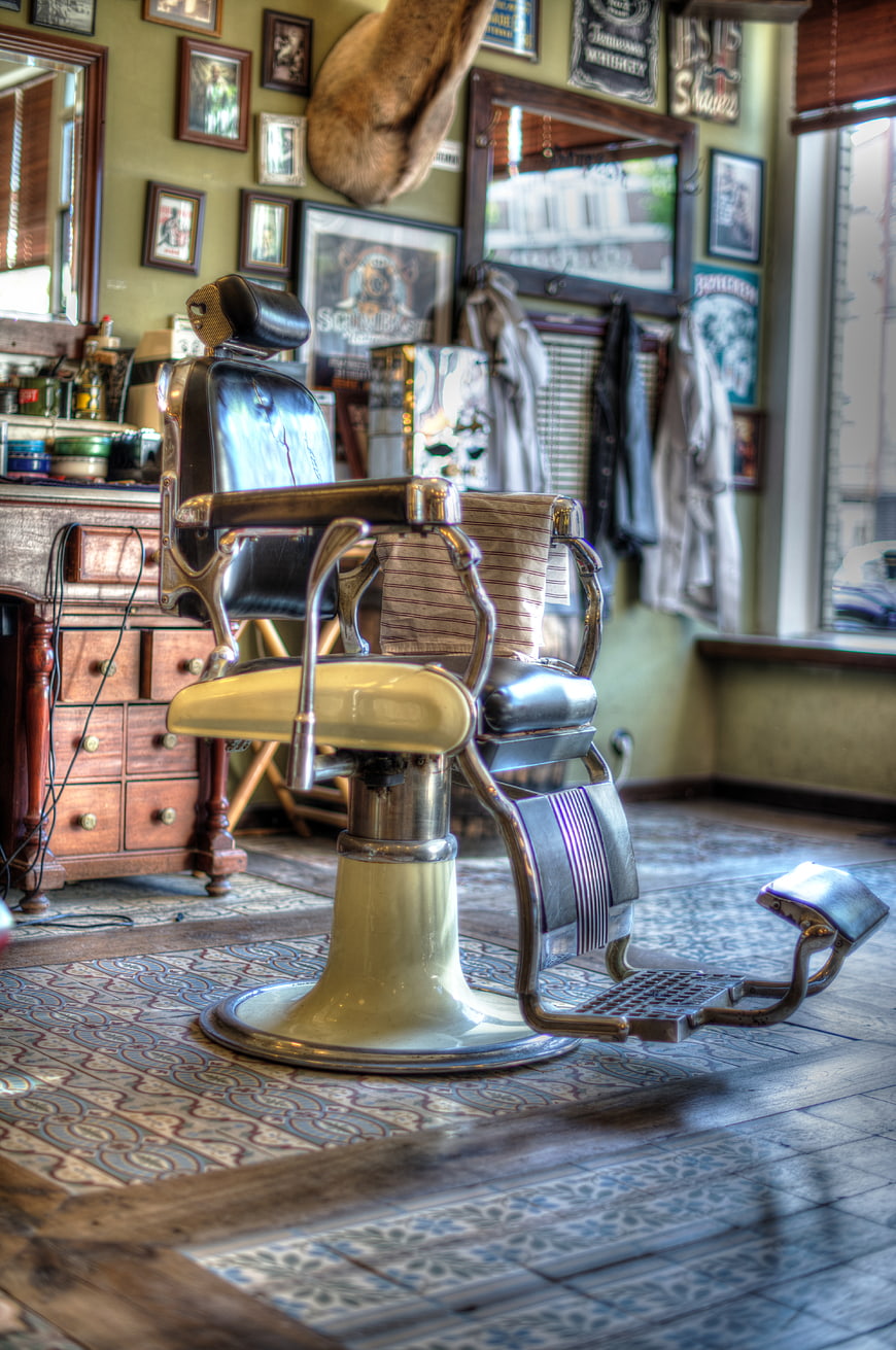 Vintage barber chair in retro shop interior