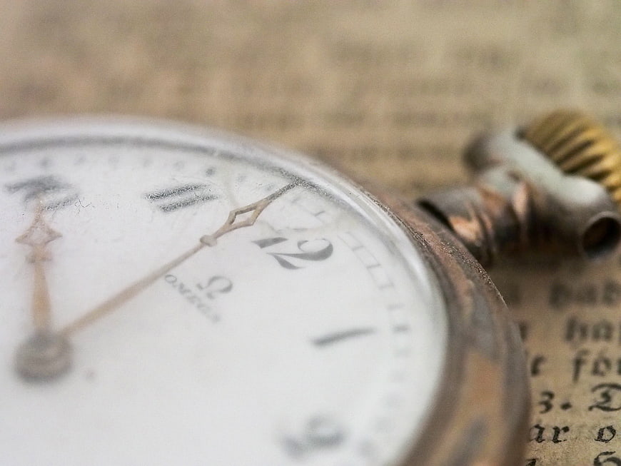 Vintage Omega Pocket Watch on Old Paper