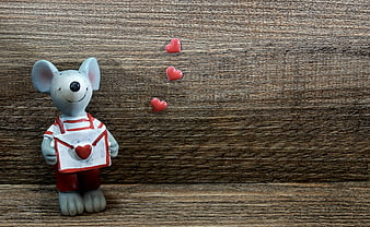 Cute Mouse Figurine Holding Love Letter On Rustic Wood Background