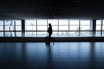 Silhouette of traveler walking in airport terminal