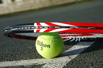 Tennis Ball And Racket On Court Line