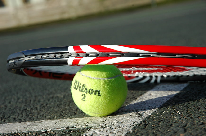Tennis Ball And Racket On Court Line