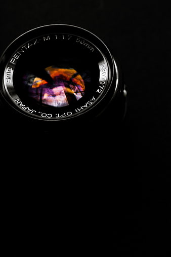 Close-up of Pentax Camera Lens with Reflection