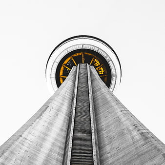 Worms eye view of concrete tower with yellow interior