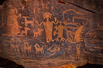 Ancient Native American Petroglyphs on Red Sandstone Rock