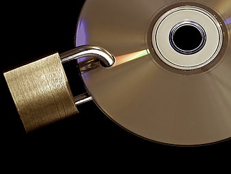 Golden Padlock Securing CD Disc on Black Background