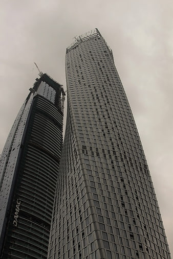 Low angle view of modern skyscrapers under construction in Dubai