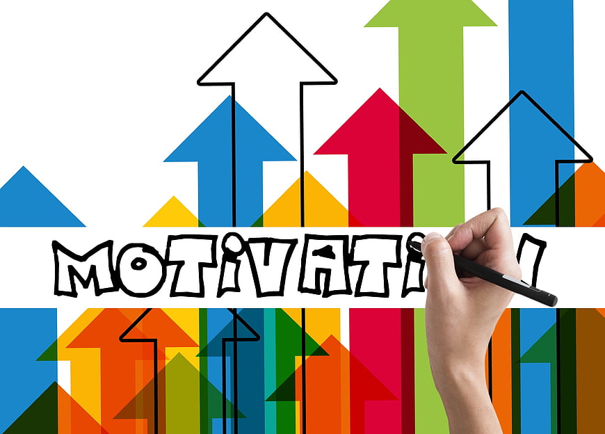 Hand writing motivation with colorful upward arrows background