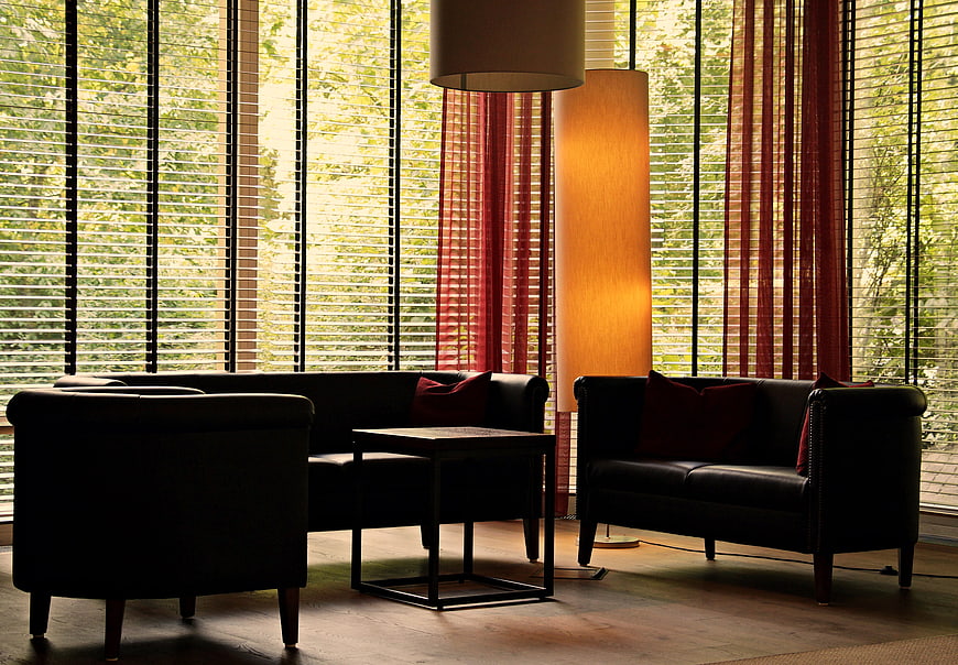 Modern Lounge Interior With Black Leather Seating And Floor Lamp