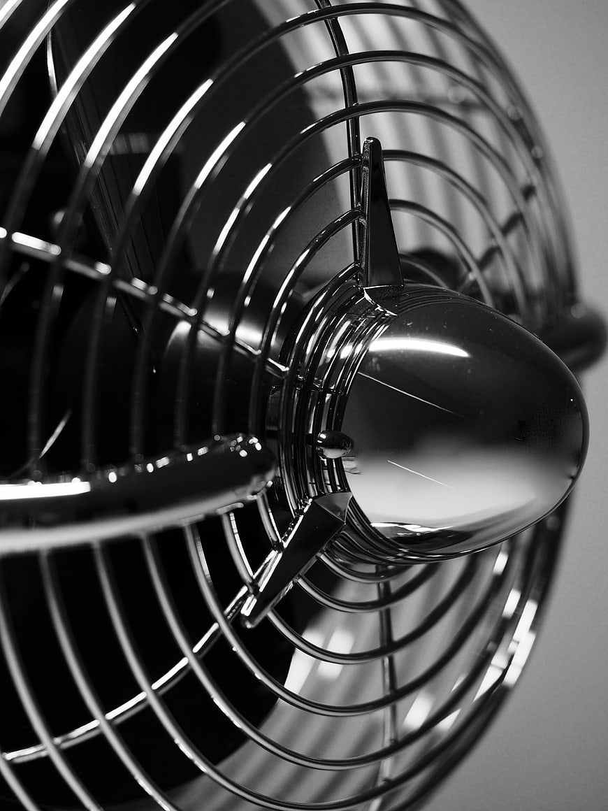 Close-up of vintage black electric fan with chrome details
