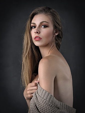 Studio Portrait of Young Woman in Off-Shoulder Knit Sweater