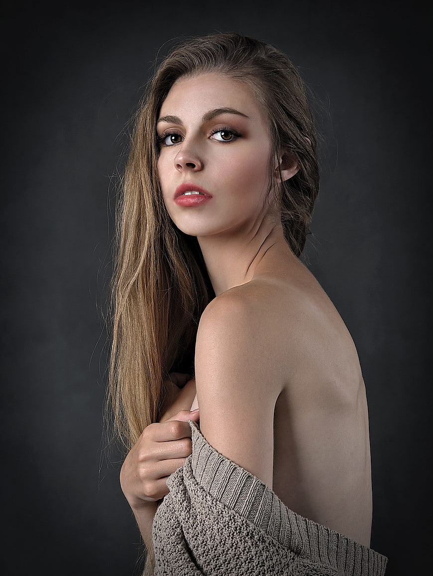 Studio Portrait of Young Woman in Off-Shoulder Knit Sweater