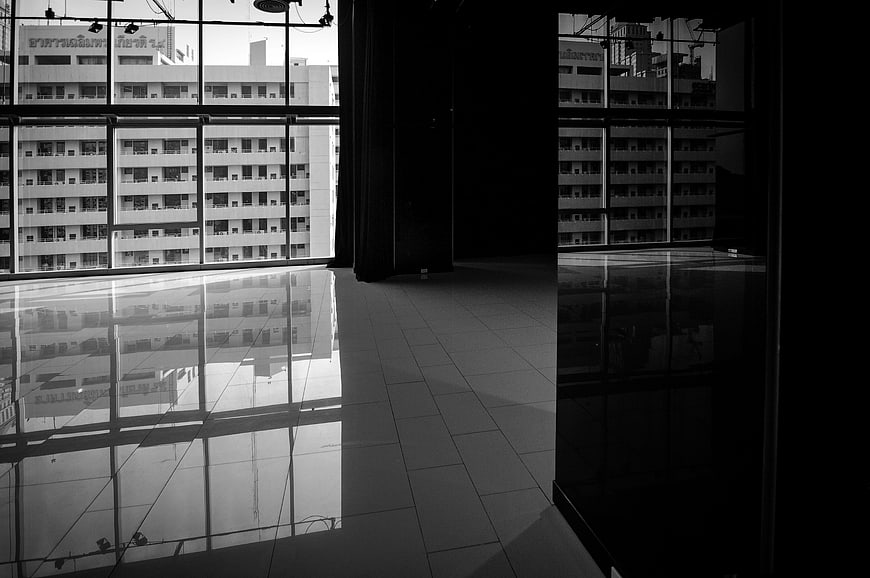 Black and white interior with city view through large windows