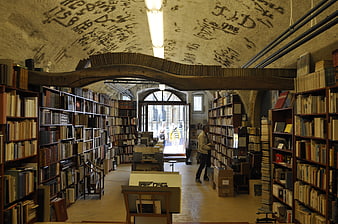 Interior of old bookstore with arched ceiling and handwritten notes