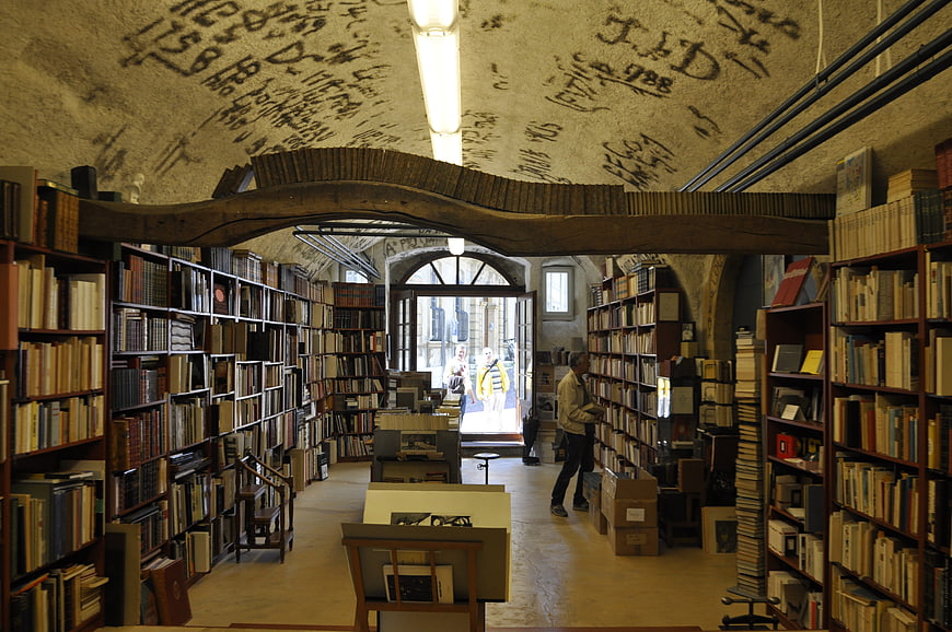 Interior of old bookstore with arched ceiling and handwritten notes