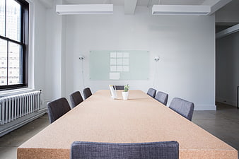 Modern minimalist conference room with cork table and white walls