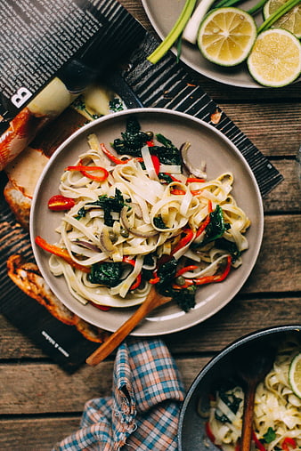 Top view of rice noodles with roasted vegetables and lime