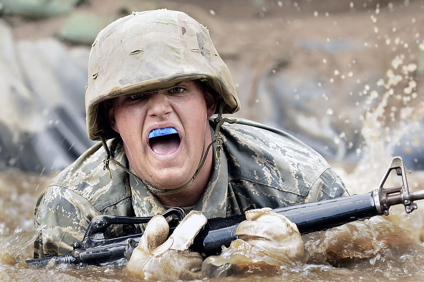 Soldier in Mud with Rifle and Mouthguard