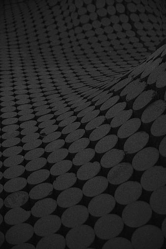 Dark abstract pattern of stacked cylindrical logs in monochrome