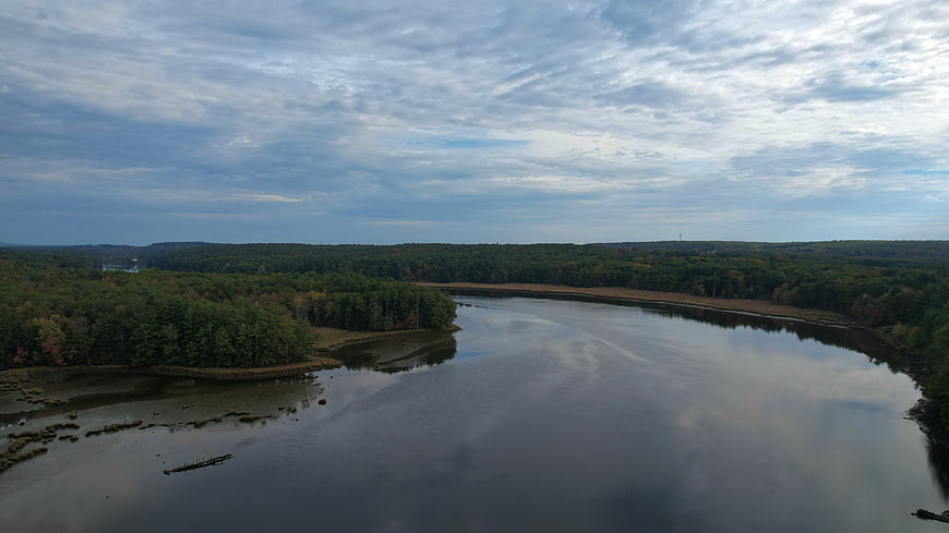 Aerial View of Serene River Winding Through Forest