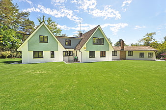 Modern Green House Exterior With Large Lawn