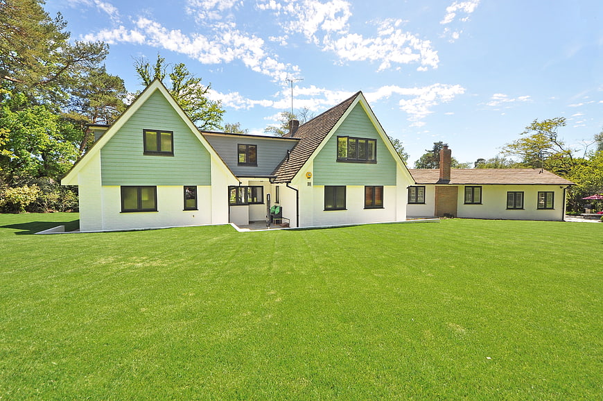 Modern Green House Exterior With Large Lawn