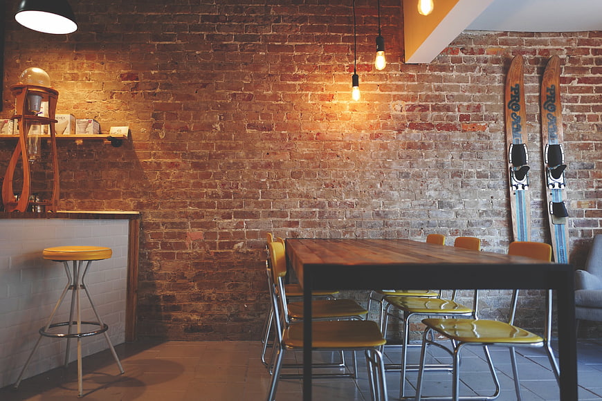 Modern Loft Interior with Exposed Brick Wall and Wooden Table