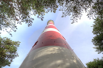 Low angle view of red and white lighthouse tower