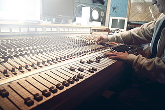 Sound Engineer Mixing Audio on Large Analog Console