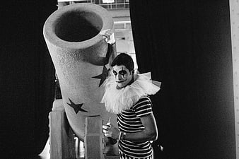 Black and white photo of a mime artist with a large prop