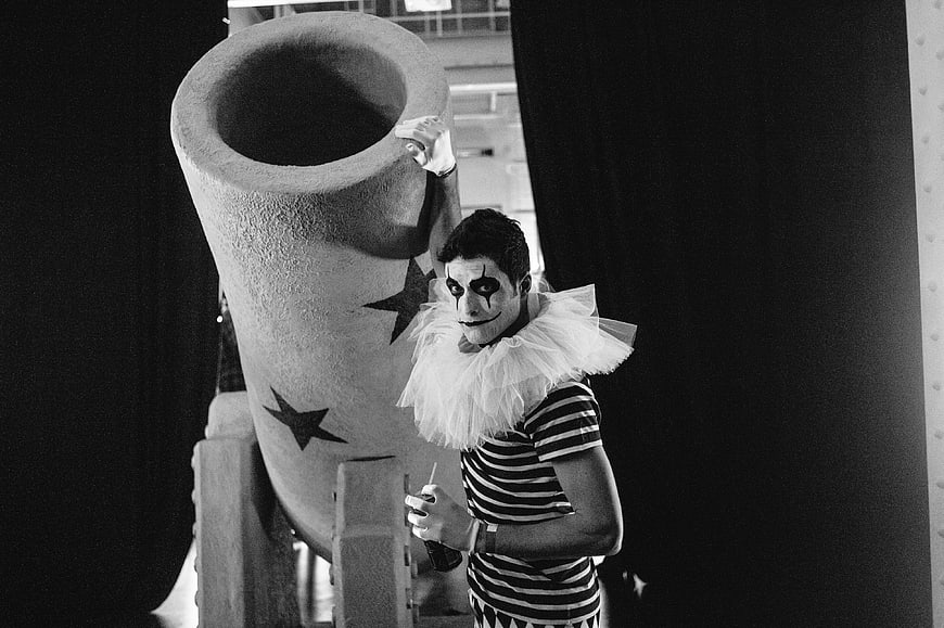 Black and white photo of a mime artist with a large prop