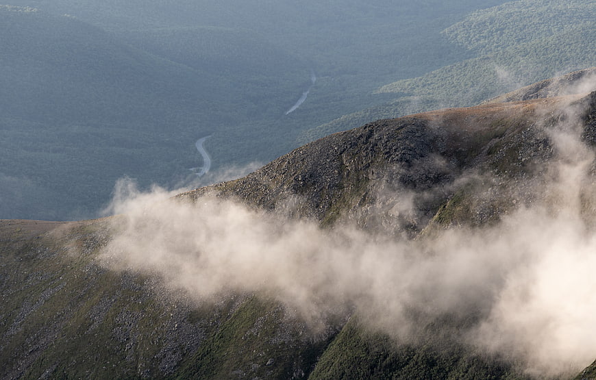 Misty Mountain Ridge with Winding River Valley Below