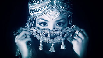 Portrait of woman in ornate traditional headdress and face veil
