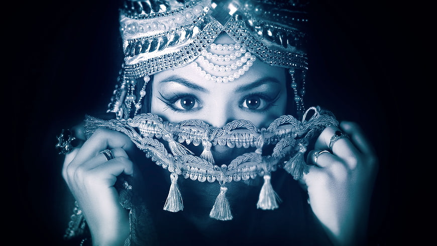 Portrait of woman in ornate traditional headdress and face veil
