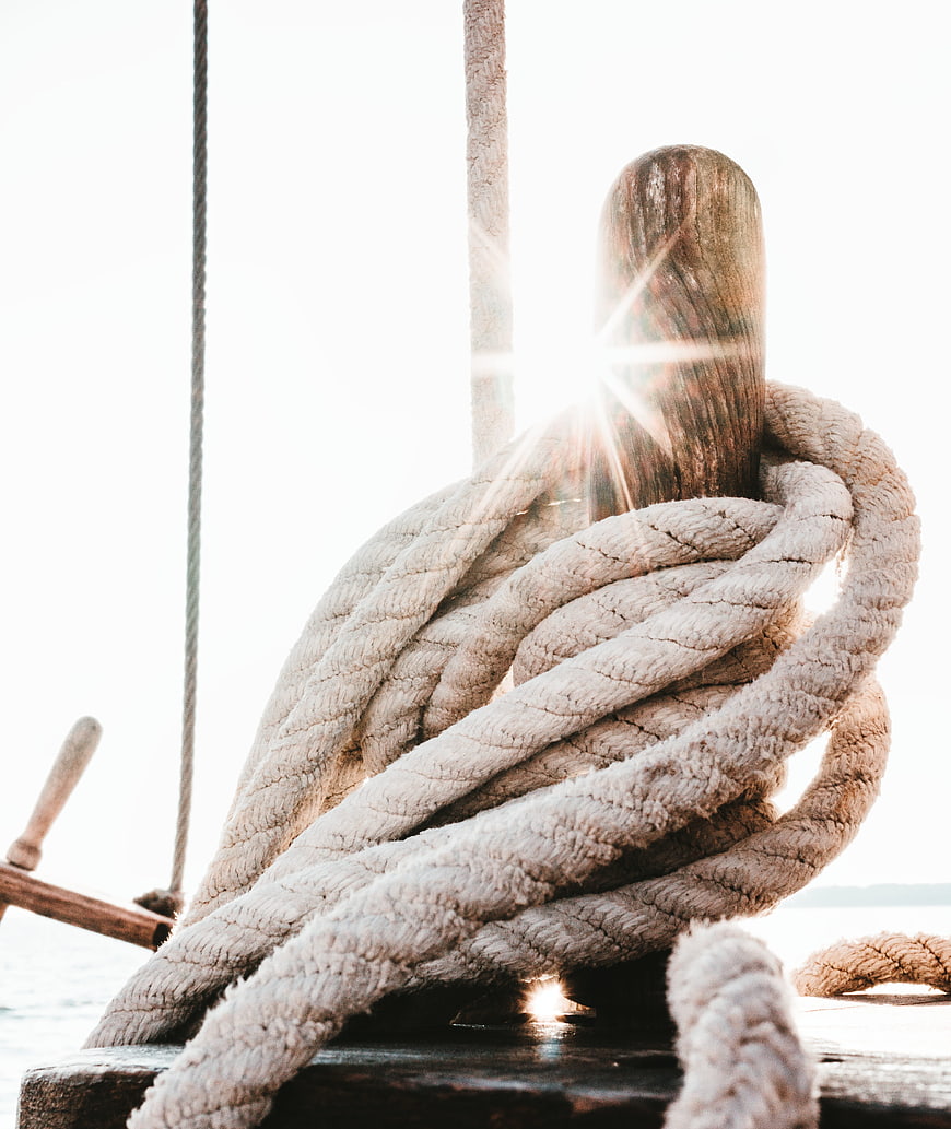 Coiled Rope on Wooden Cleat with Sun Flare