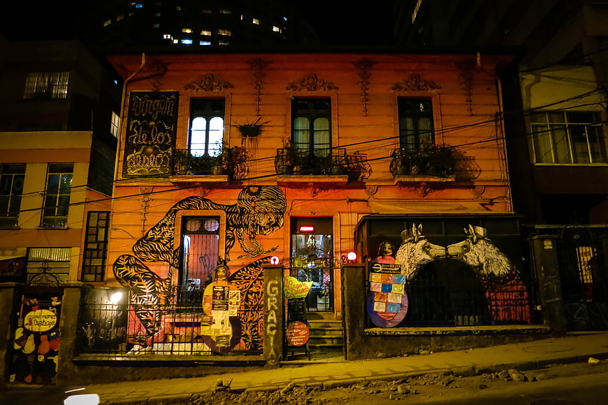 Colorful Graffiti Mural on Orange Building at Night
