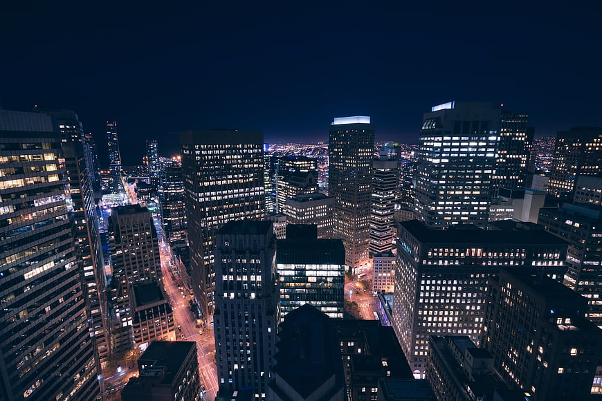 Aerial Night View of Downtown City Skyline with Illuminated Skyscrapers
