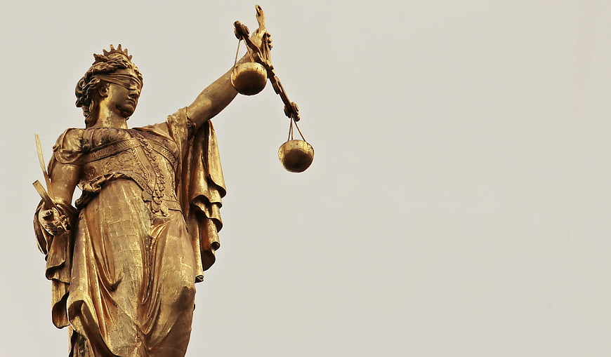 Golden Statue of Lady Justice Holding Scales and Sword