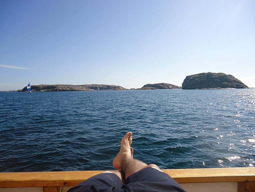 Relaxing on a boat with feet up overlooking ocean islands