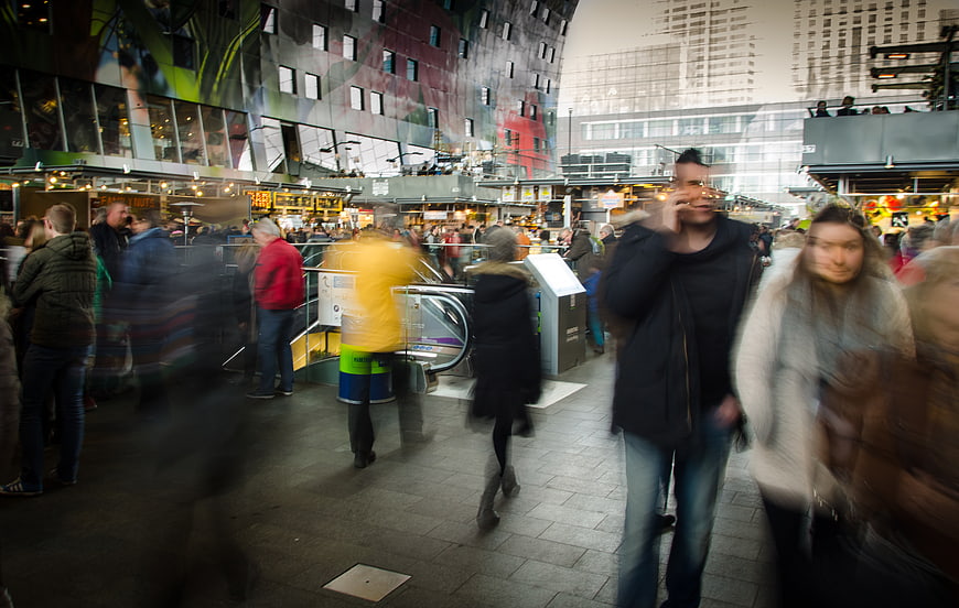 Motion blur crowd walking in busy indoor shopping mall